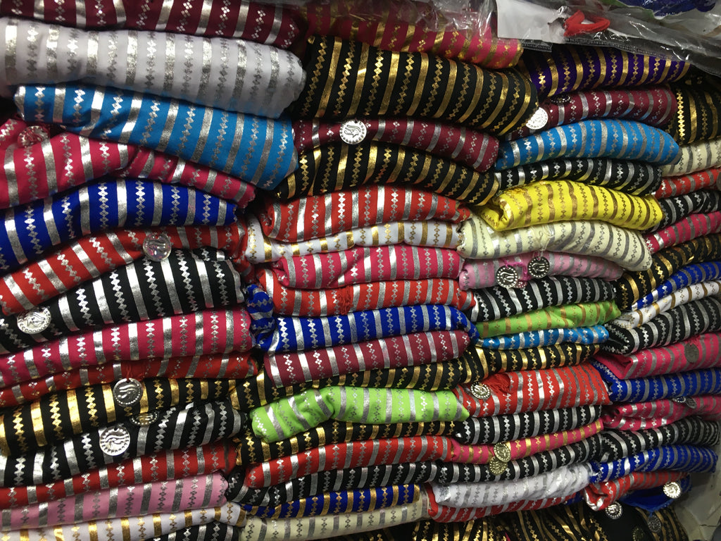 A person wearing a traditional Egyptian Saidi costume, featuring a black and blue striped pattern, commonly known as a Galabia, used for belly dance performances.