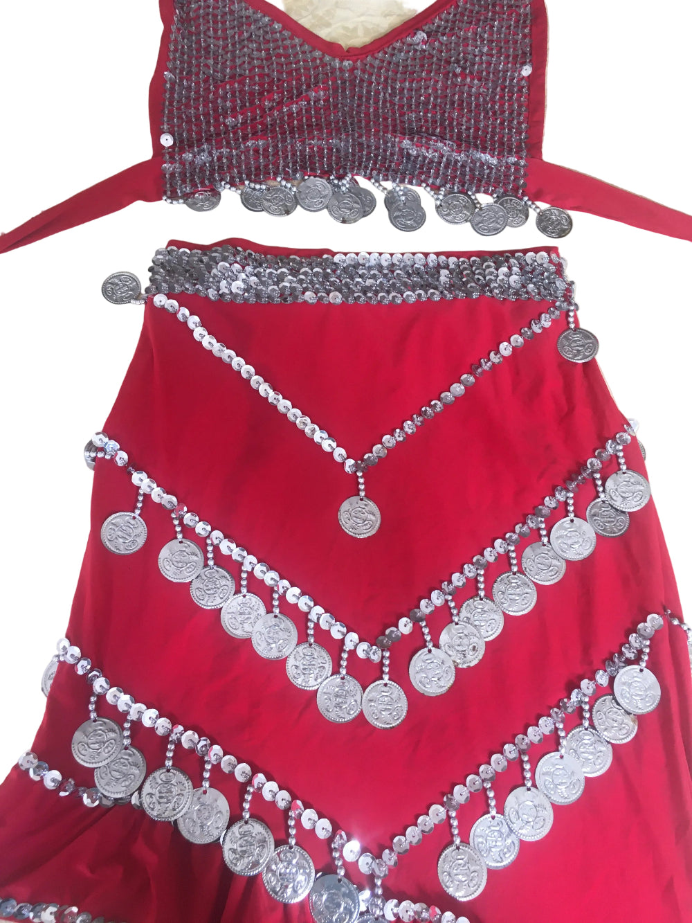 Red garment with silver embellishments on a beige background