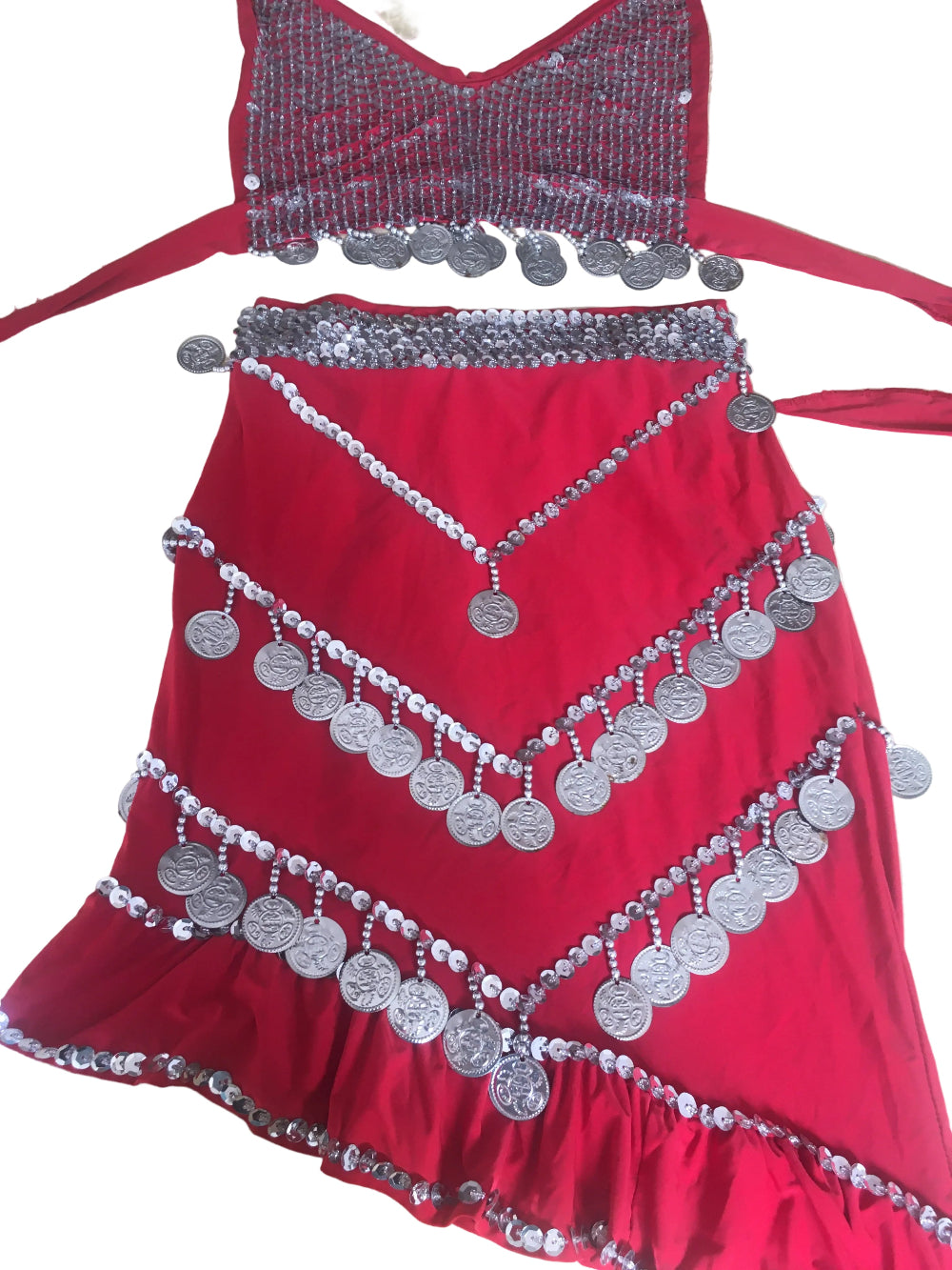 Red garment with silver coin detailing on a beige surface