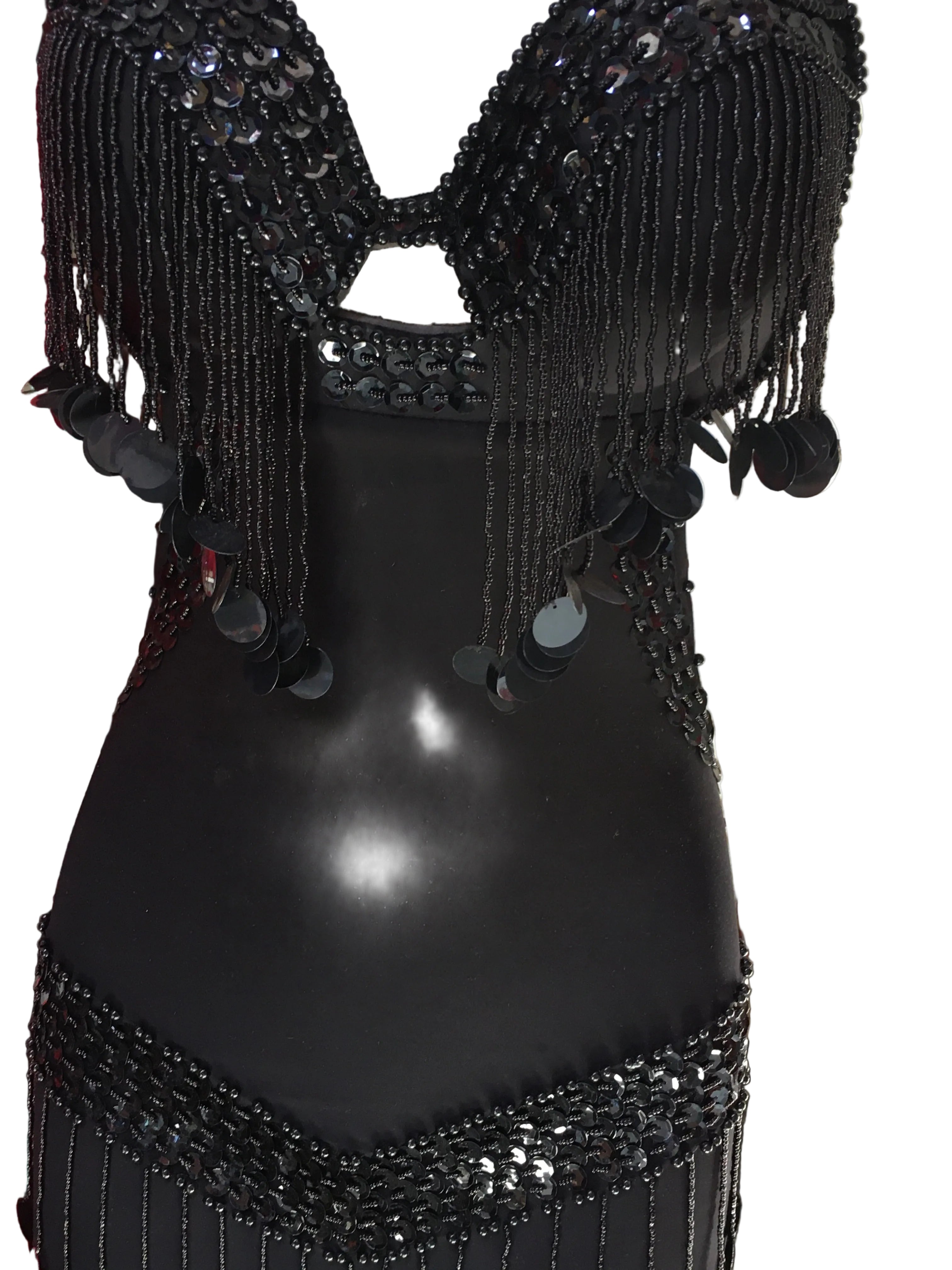 Black beaded top with intricate designs on a red background