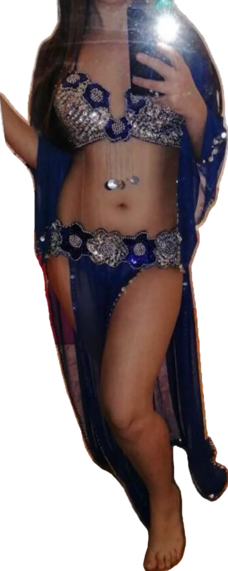 Belly dancer in a blue costume with intricate designs on a white background