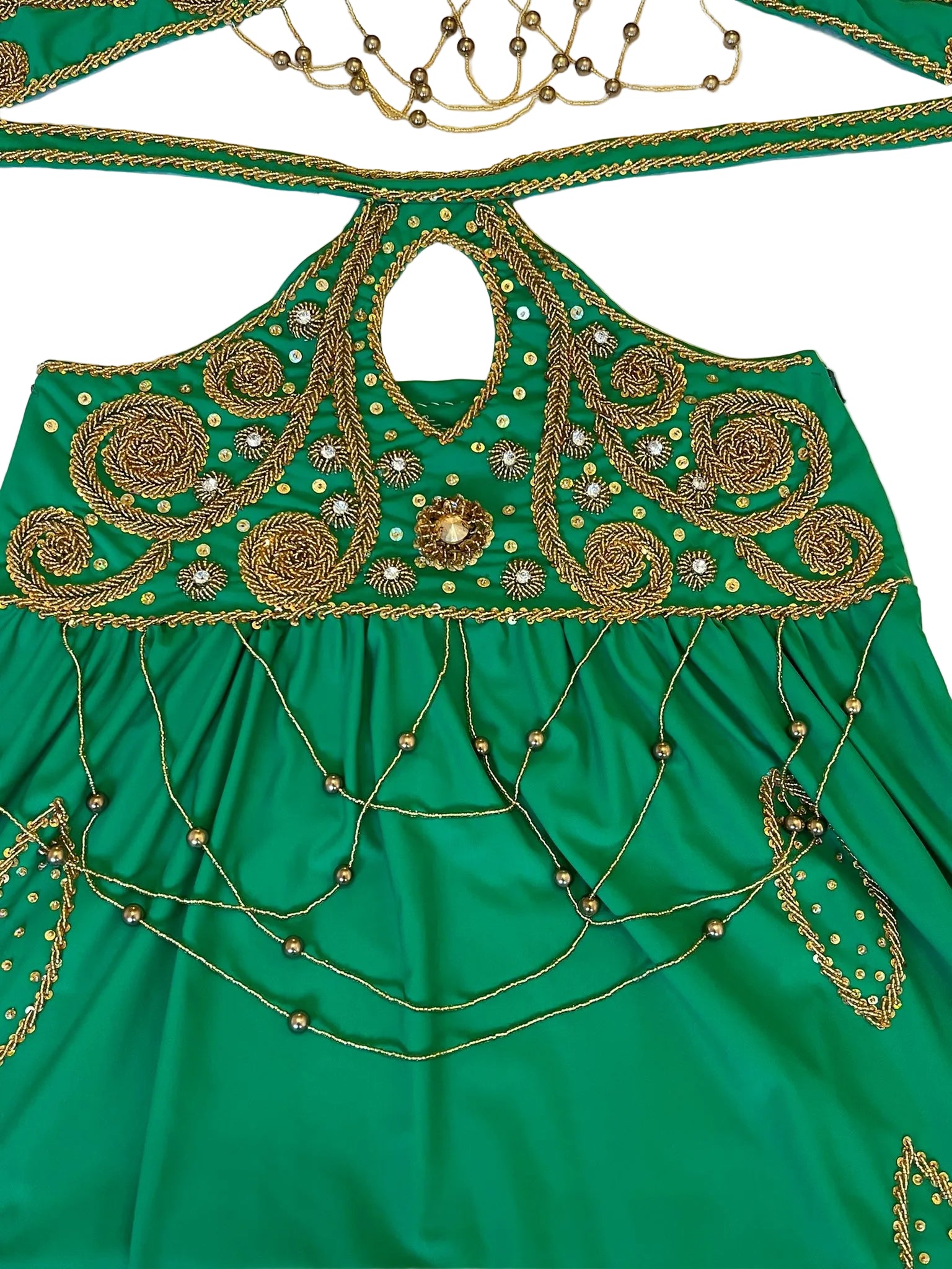 Green fabric with intricate gold embroidery on a white background