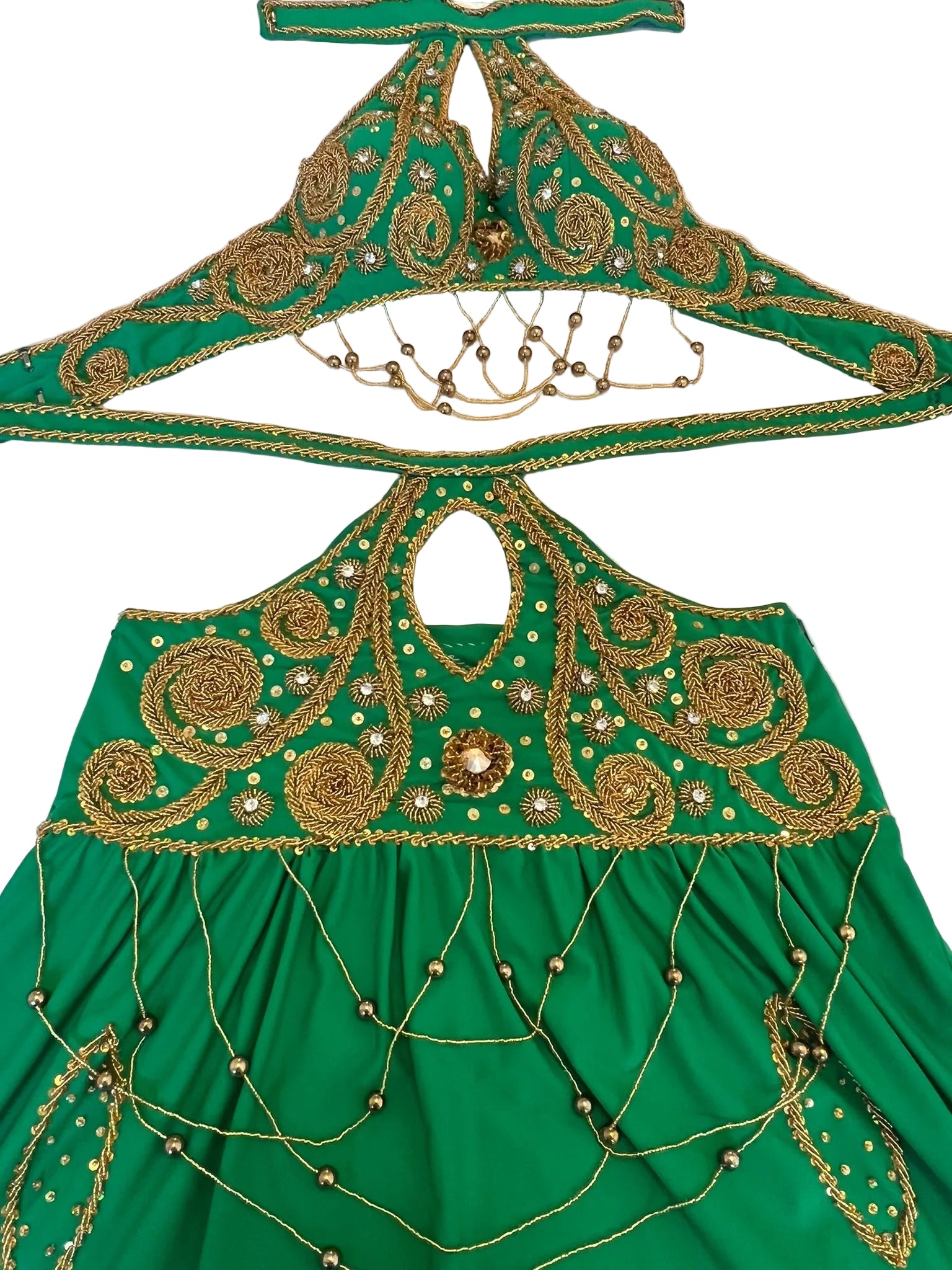 Green fabric belly dance costume with gold embroidery and beadwork on a white background