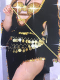 A person wearing an Egyptian belly dance costume with black and gold colors, including a bra and a long skirt, holding a wand, against a sparkling background.