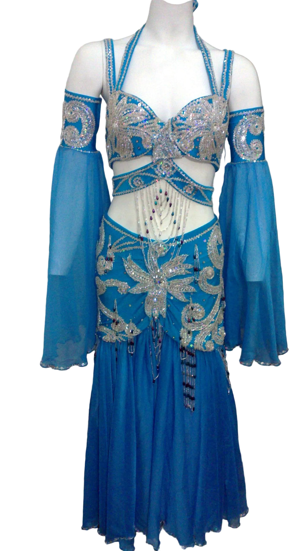 A blue professional belly dance costume with intricate embellishments, including a bra, two-part skirt, sleeves, headband, and chiffon veil.