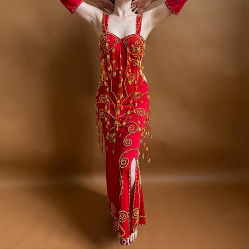 Red embroidered Belly dance dress with gold details on a brown background