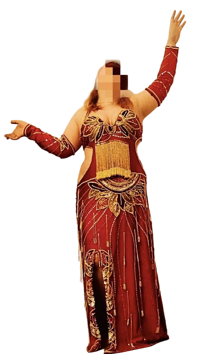 Red and gold traditional outfit with intricate patterns on a white background