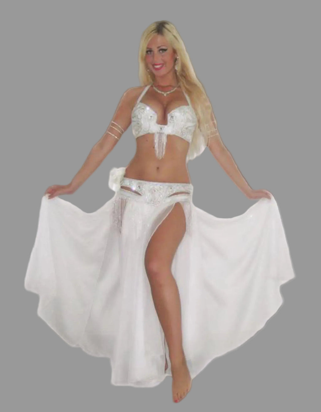 Woman wearing a white lingerie set with a flowing skirt on a black background