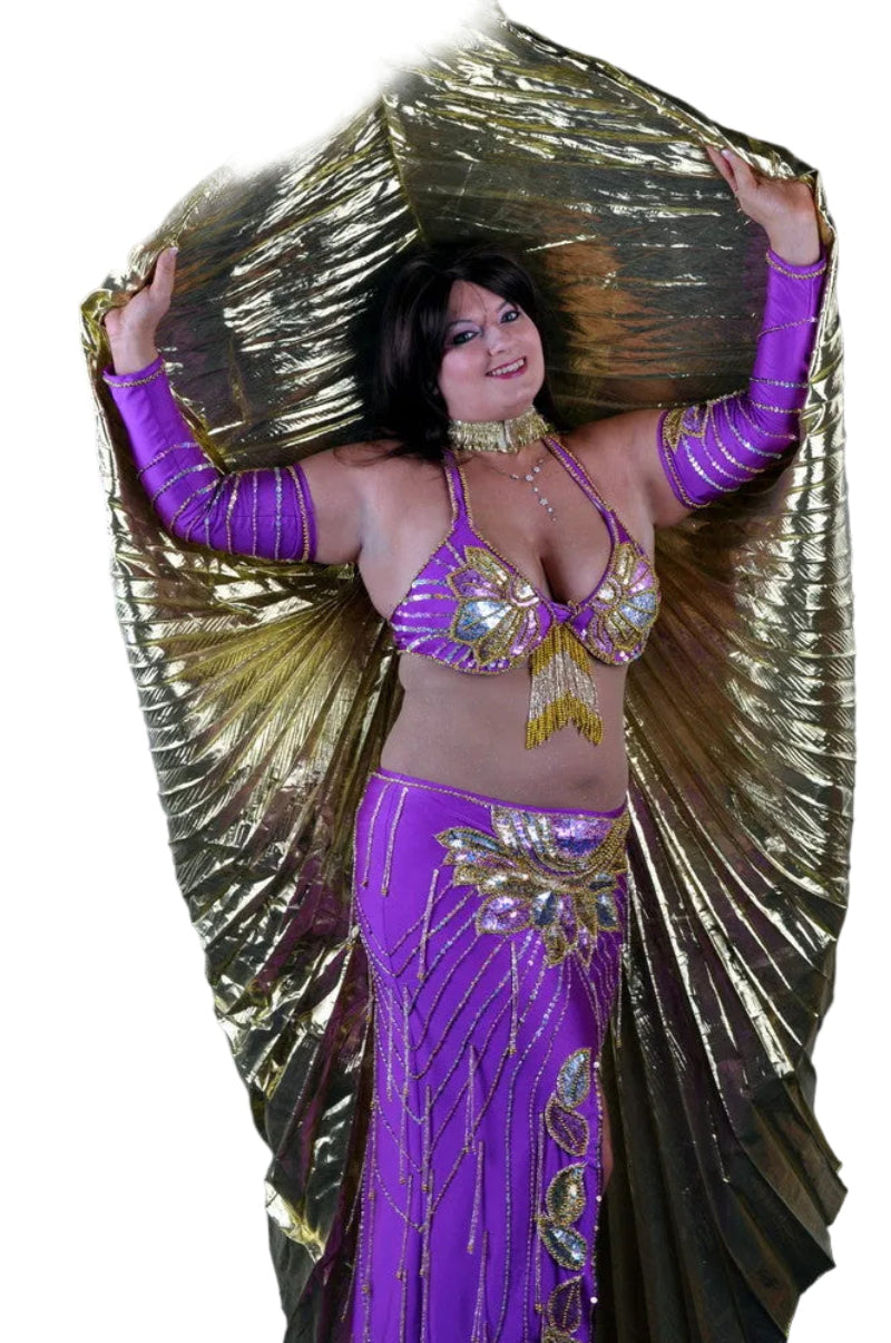 Dancer in a purple costume with gold accents and wings on a white background
