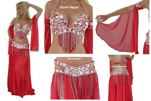 Red belly dance costume with silver embellishments and 'Luxor Bazar' branding.