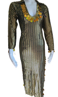 Mannequin wearing a black and gold dress with decorative elements, branded 'Luxor Bazar'.
