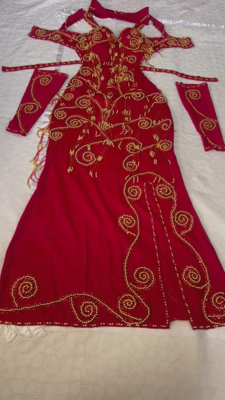 A video showing professional red belly dance outfit handmade embellished with golden beads and pearls 