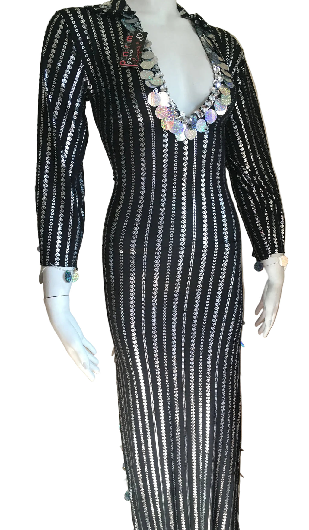 Mannequin wearing a black and white patterned dress with a necklace against a neutral background