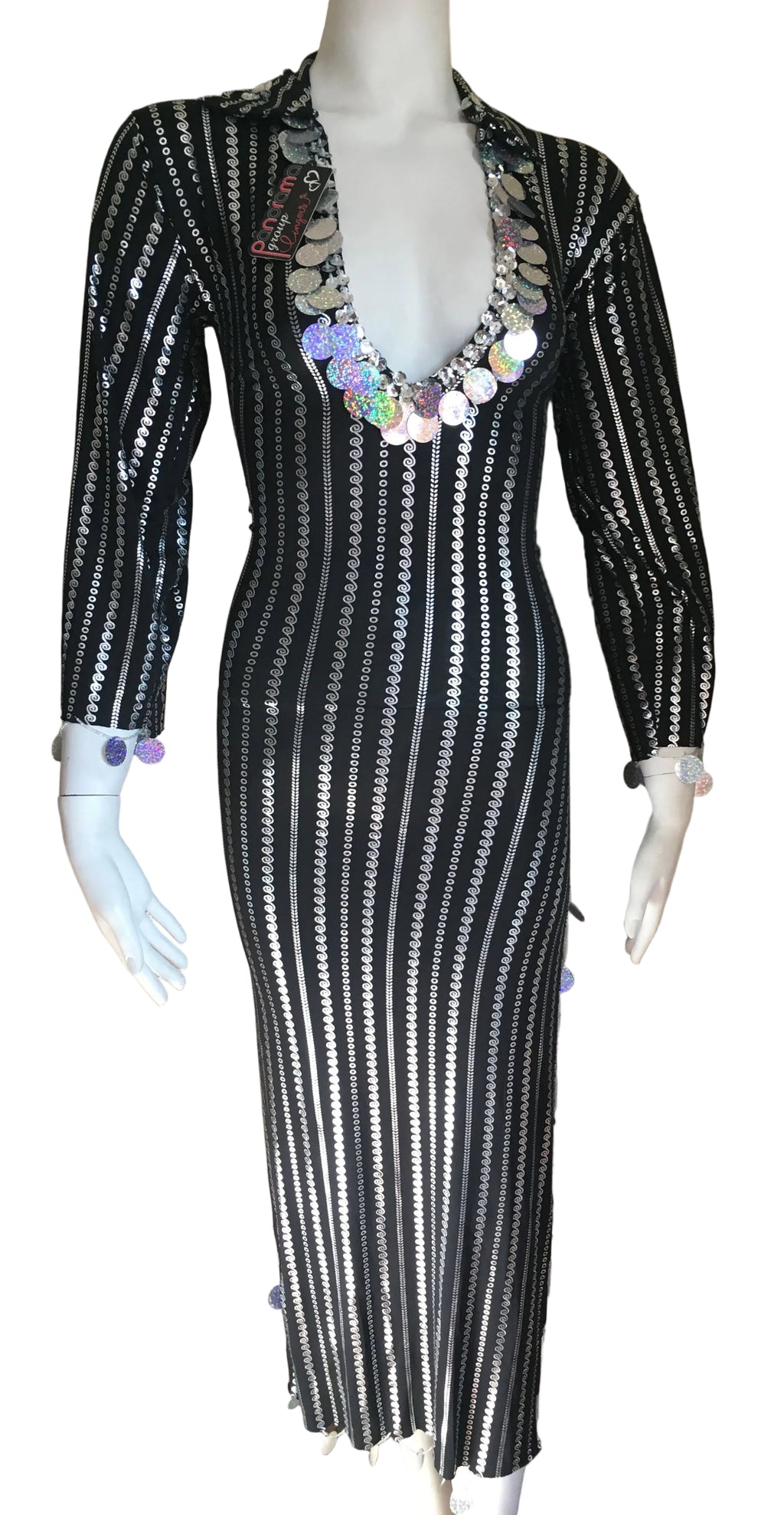 Black and white striped dress with sequin embellishments on a mannequin against a beige wall.