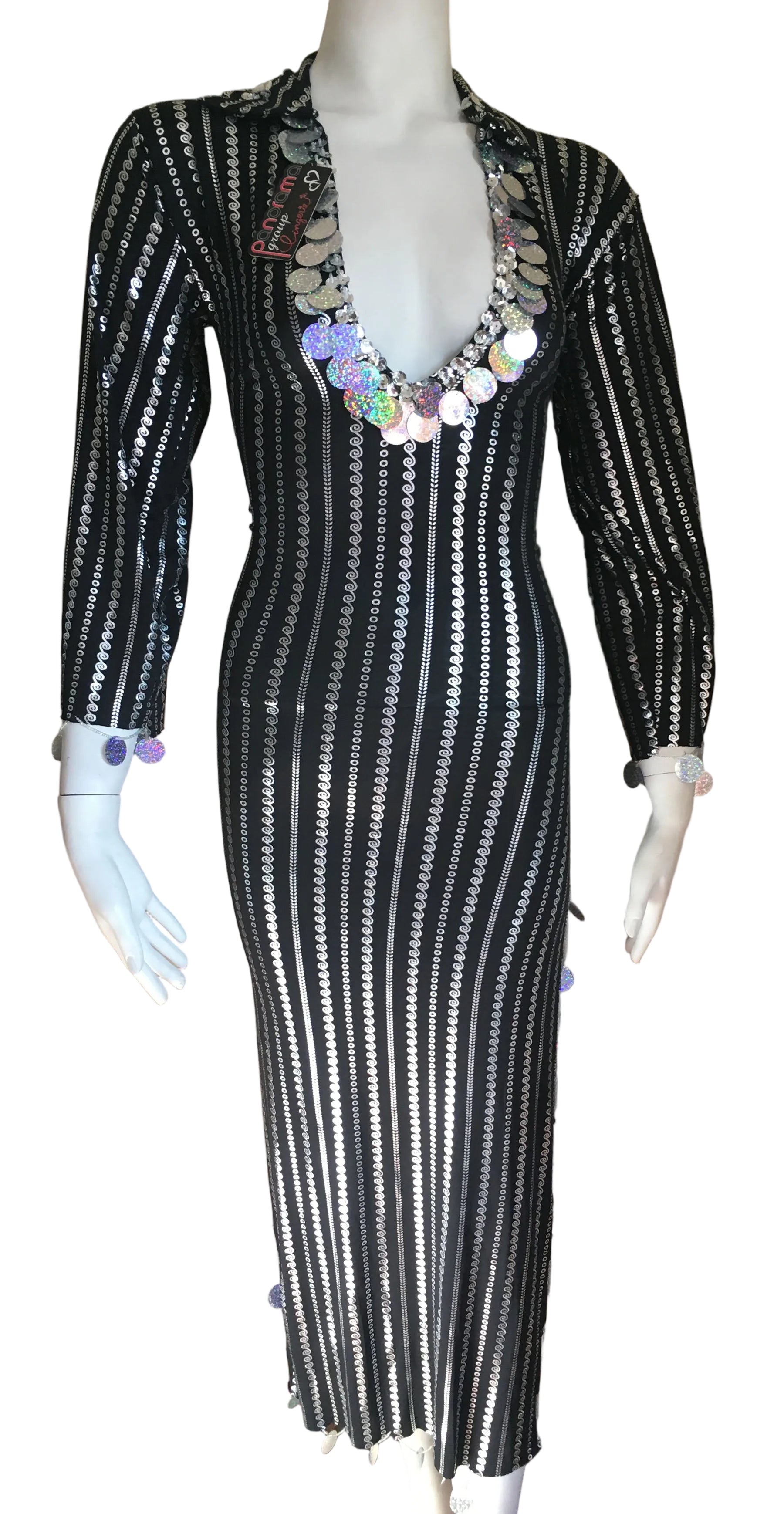 Black and white striped dress with sequin embellishments on a mannequin against a beige wall.