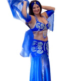 A person wearing a blue belly dance costume with detailed embellishments, including a wide chiffon skirt, bra, belt, sleeves, headband, and a chiffon veil, posing with arms raised.