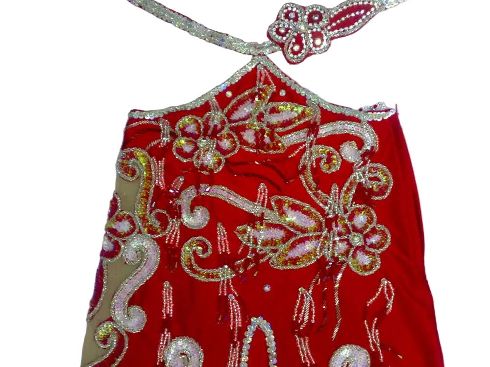 Red embroidered garment with floral patterns on a white background